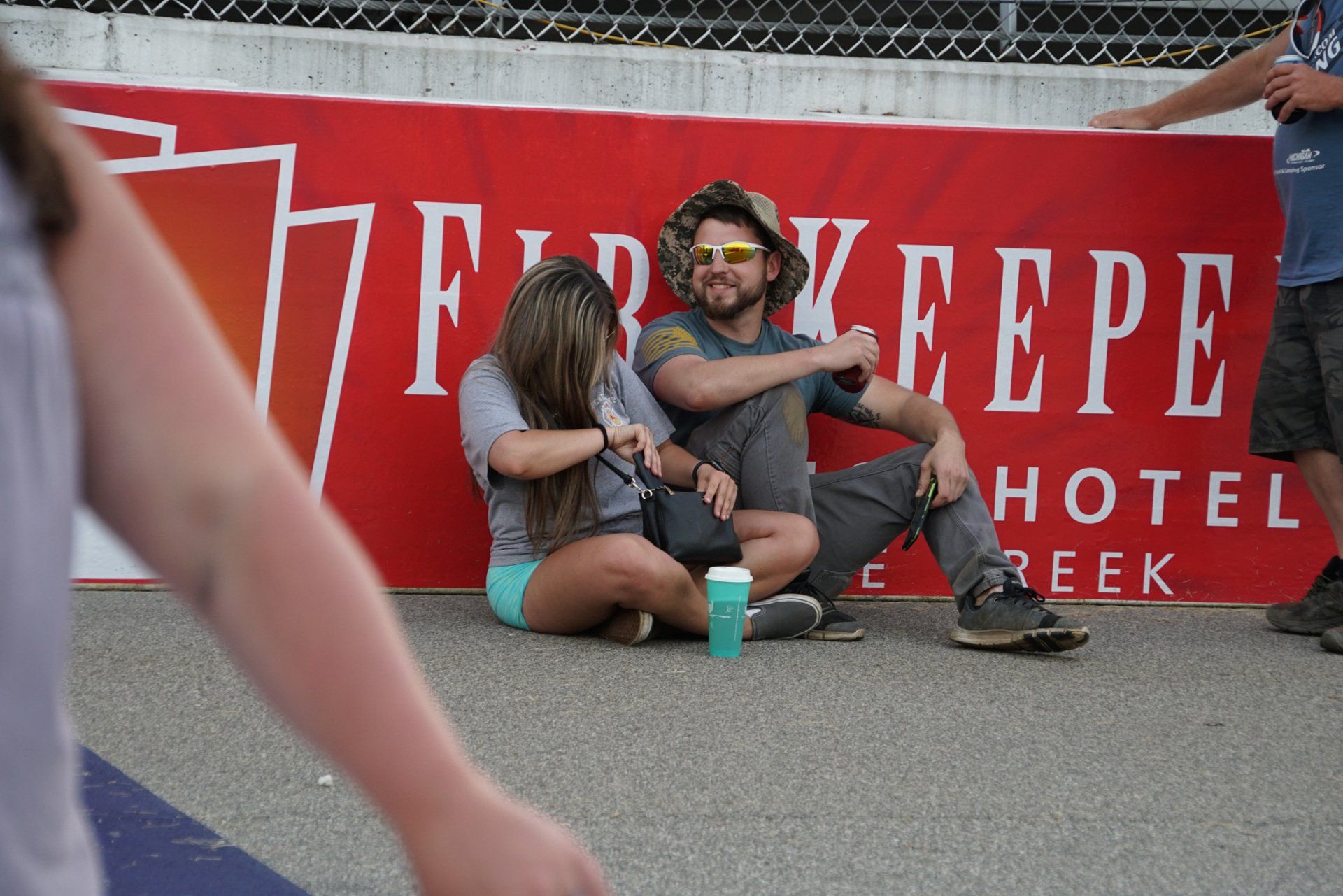People sitting in front of a sign that says hotel reek