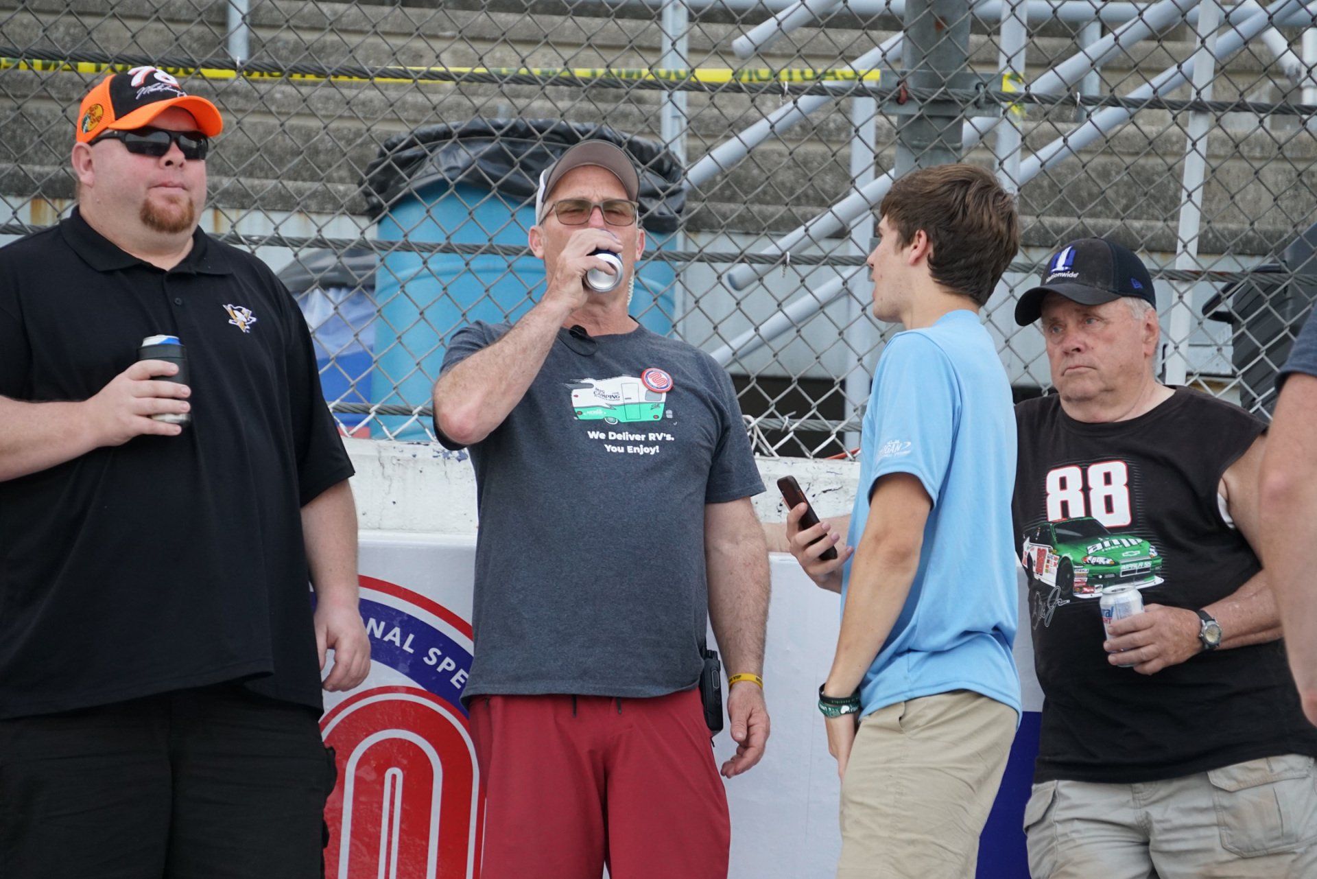 A group of men standing in front of a sign that says a8