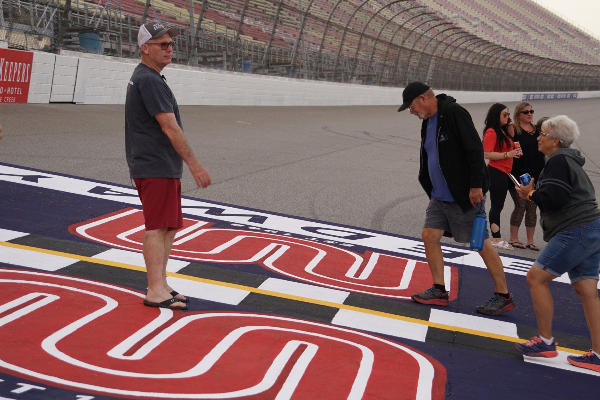 A group of people are standing on a race track