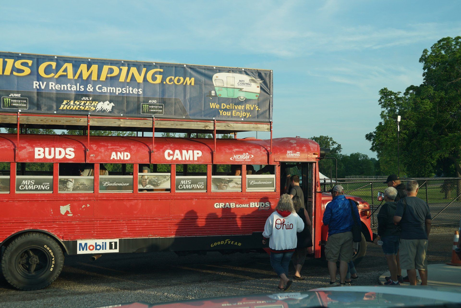 A red bus with the words buds and camp on the side