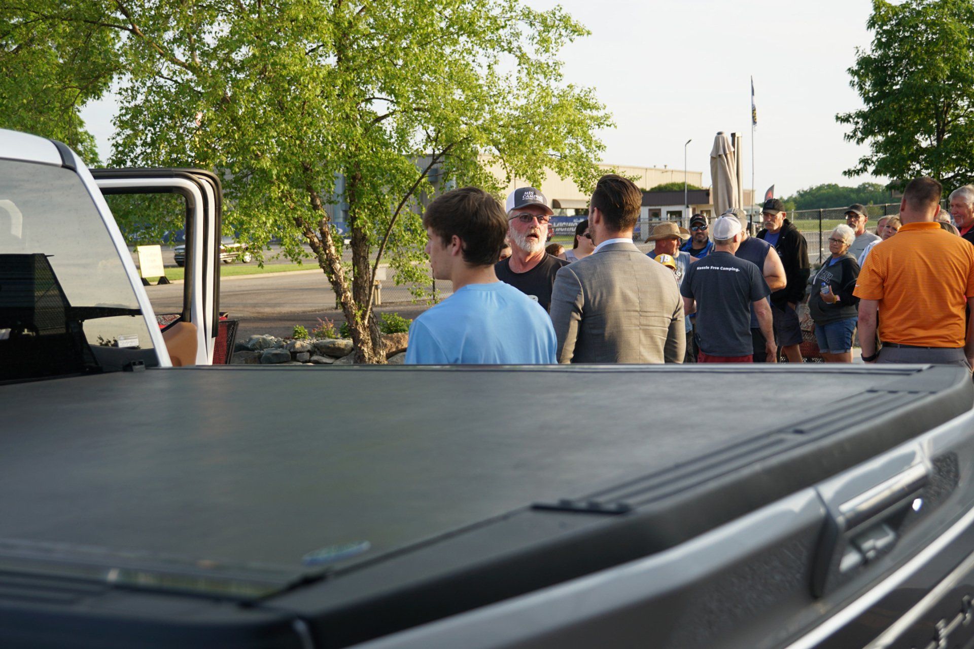 A group of people are standing in front of a truck