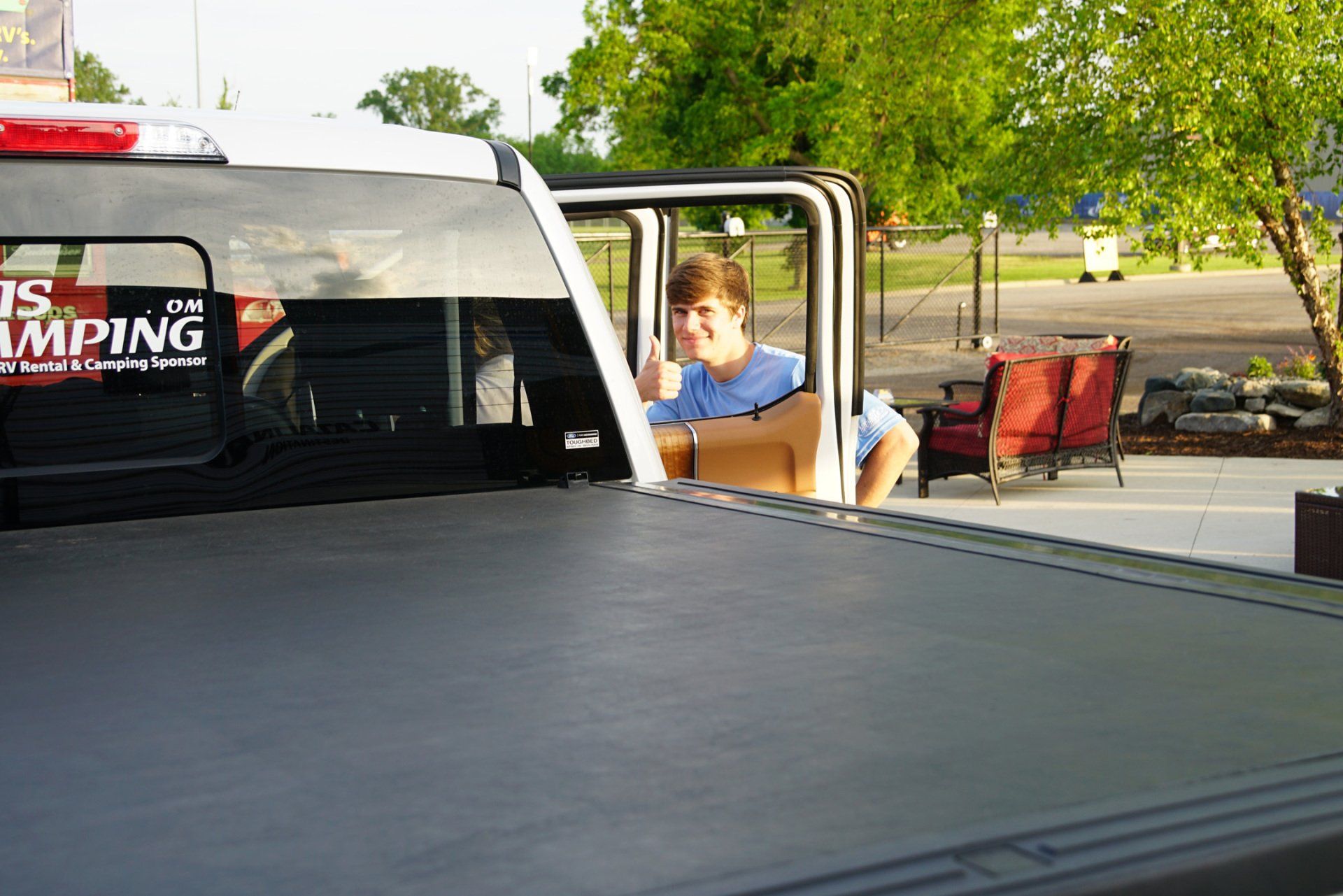 A truck with a sticker on the back that says ' ts camping '