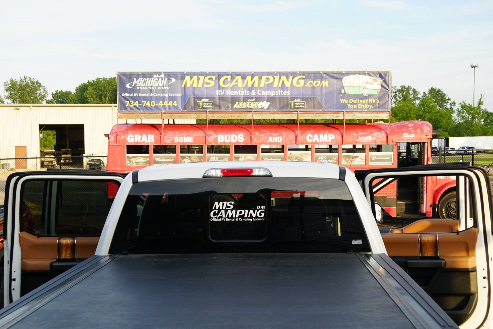 A truck is parked in front of a miscamping sign