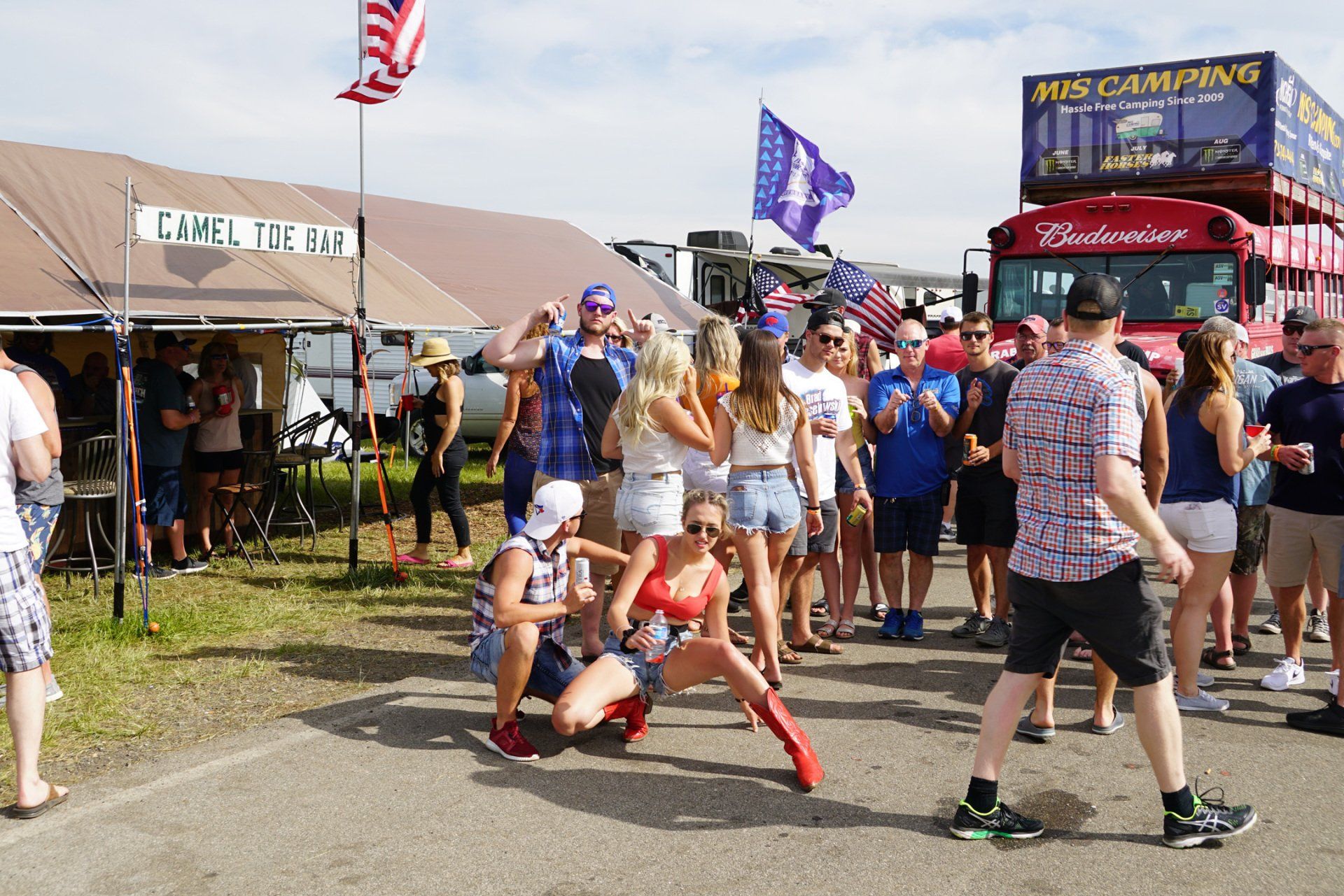 A group of people are gathered in front of a budweiser truck