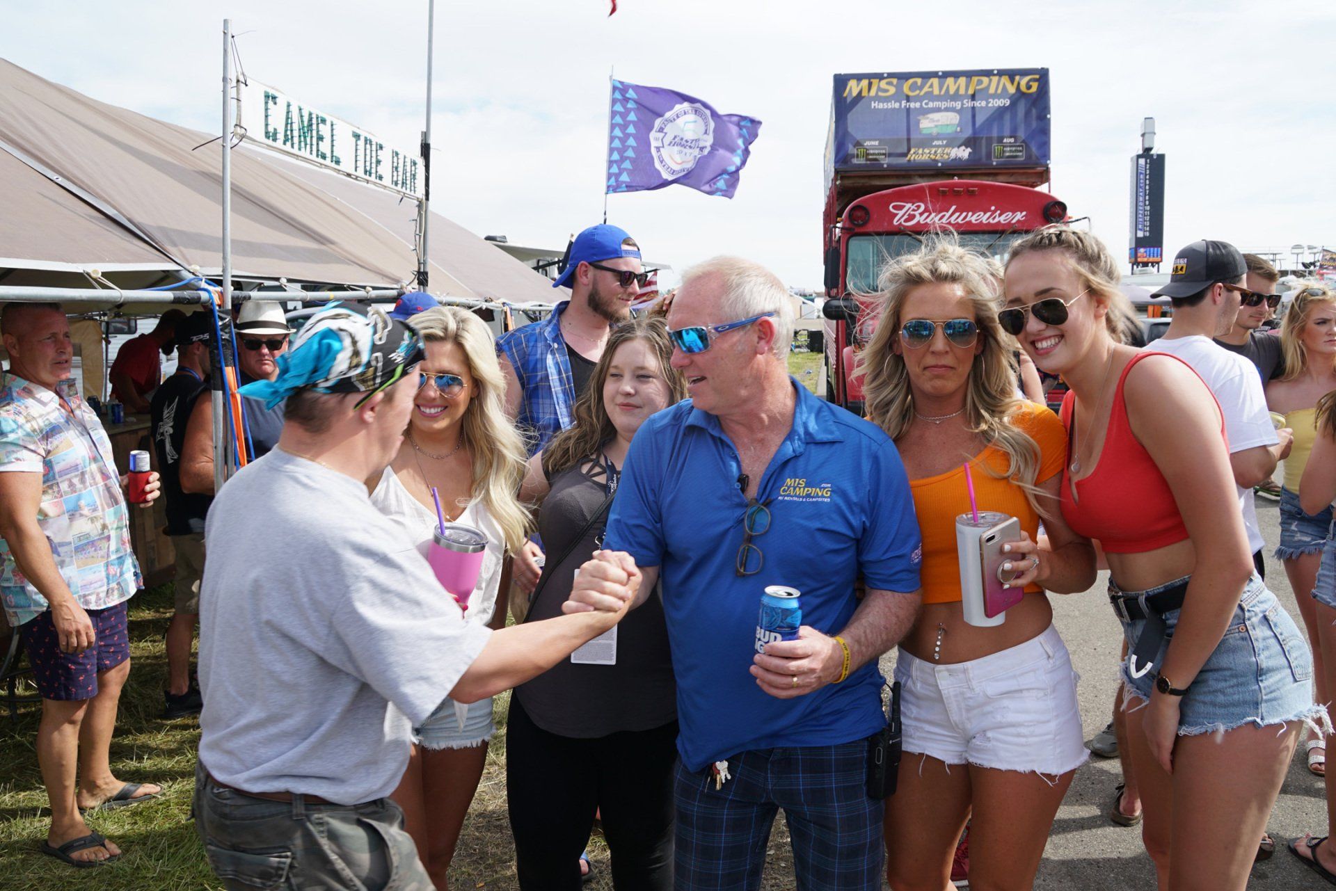 A group of people are posing for a picture at a festival.