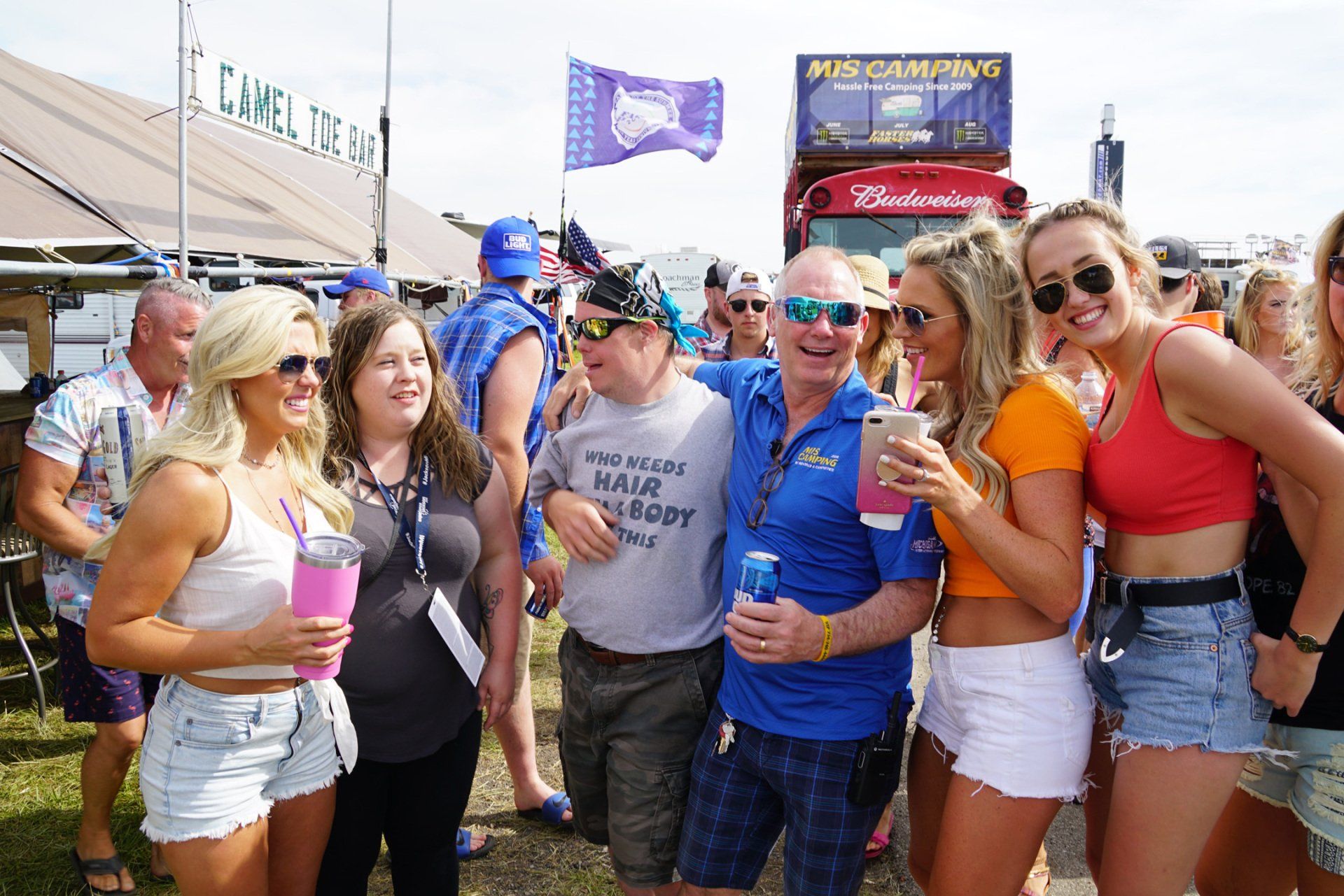 A group of people are posing for a picture at a festival.