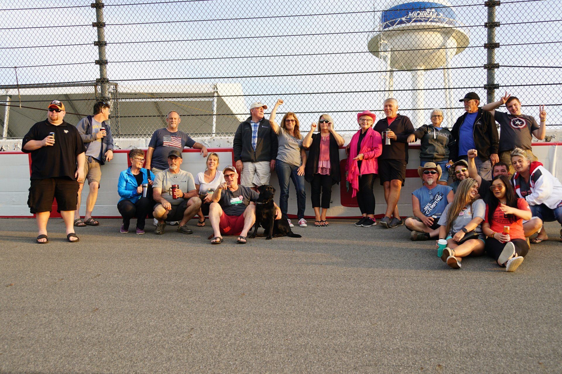 A group of people posing for a picture in front of a water tower