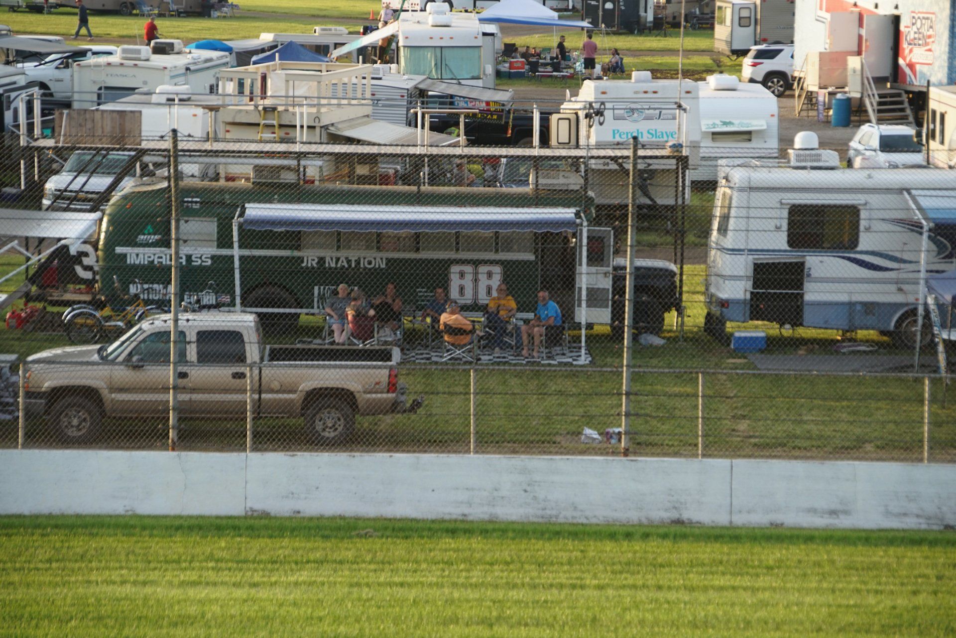 A truck is parked next to a bus that says bp on it