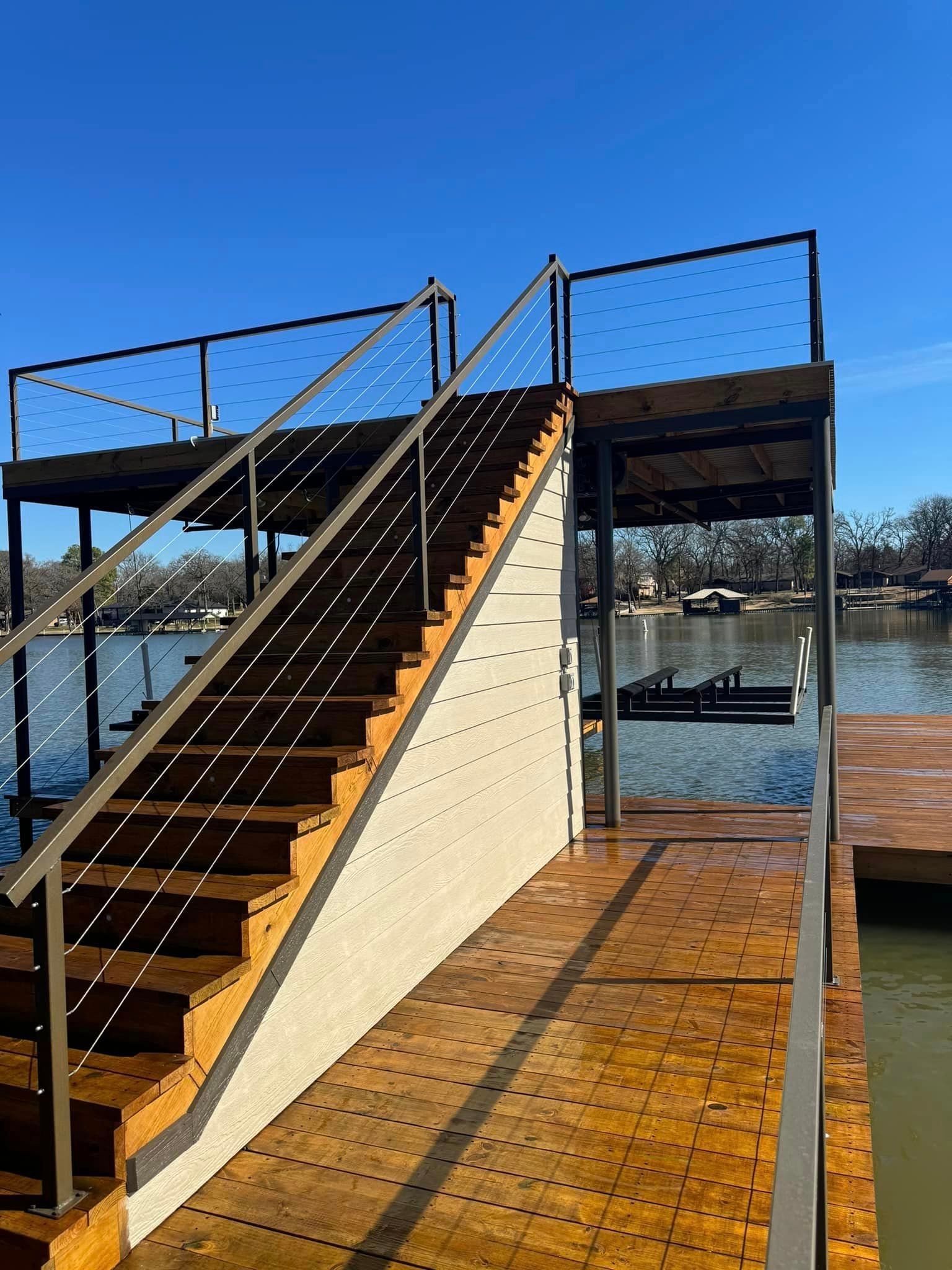 A set of stairs leading up to a dock overlooking a body of water.
