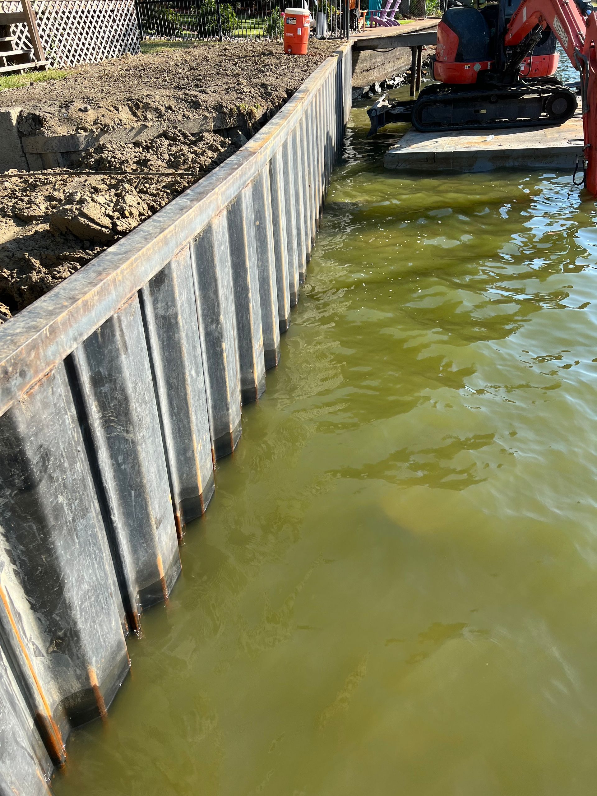 A large body of water with a concrete wall in the middle of it.