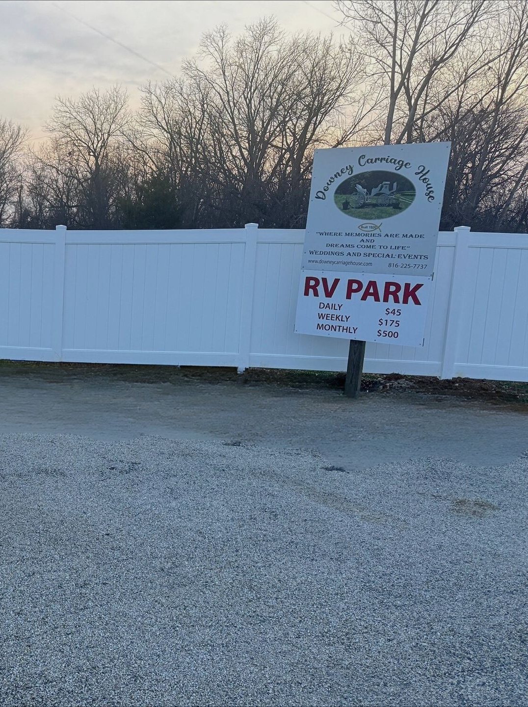 Downey Carriage House RV Park entrance sign with daily, weekly, and monthly RV parking rates displayed