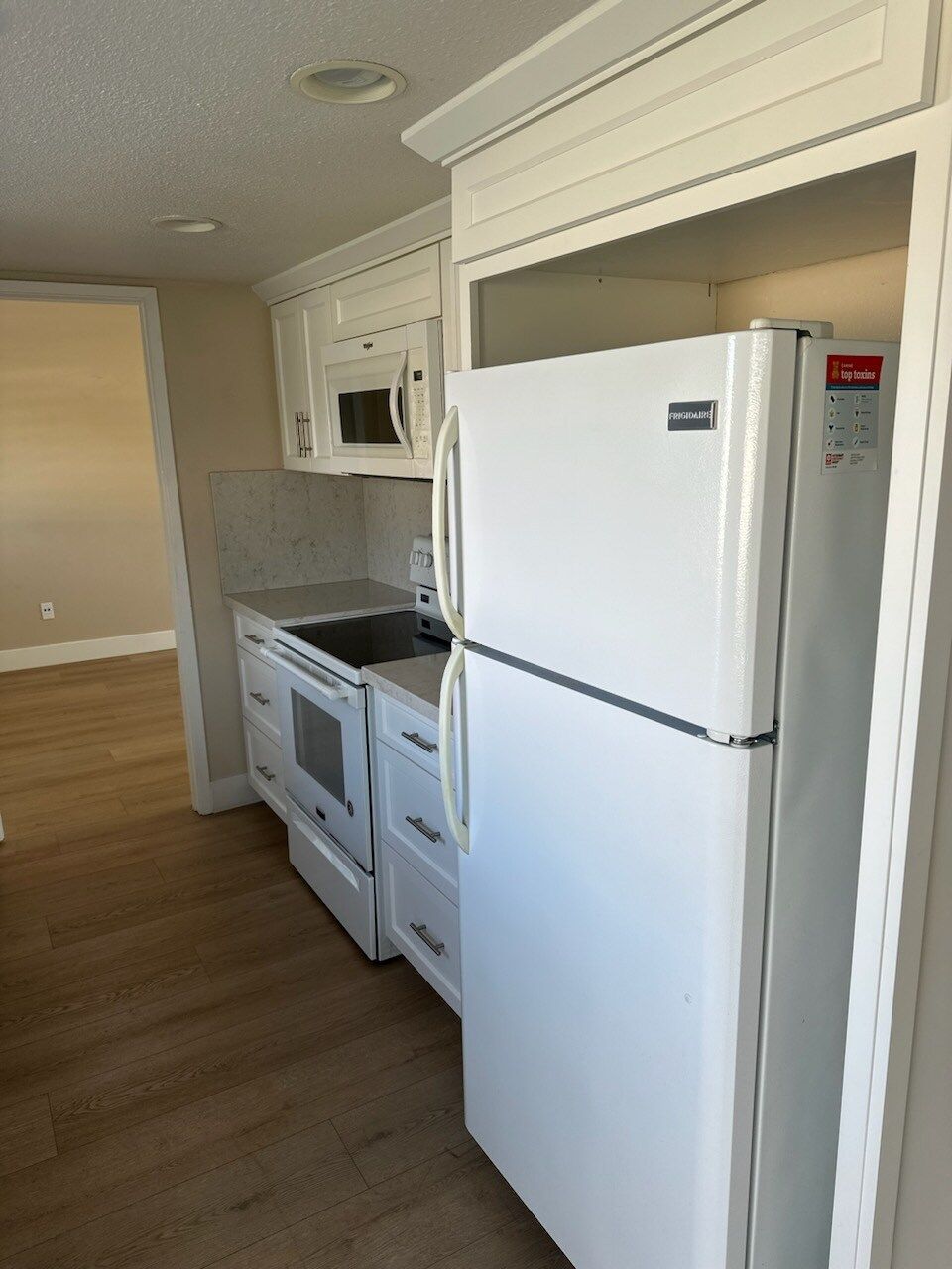 A kitchen with a refrigerator stove and microwave