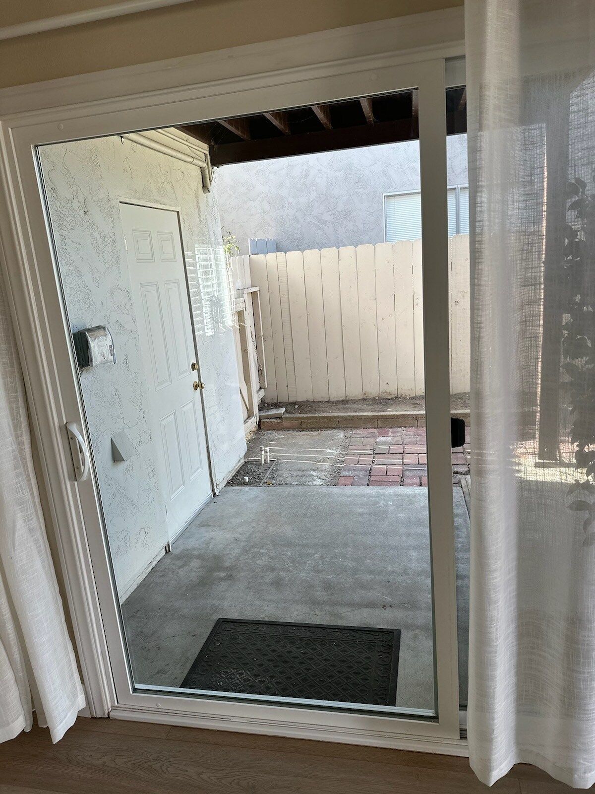 A sliding glass door is open to a patio.