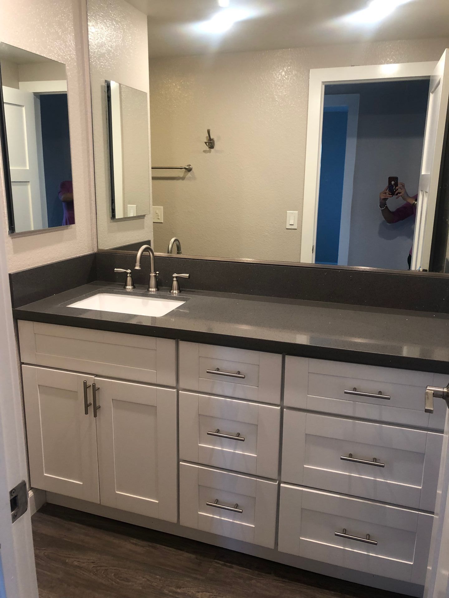 A bathroom with two sinks and a large mirror