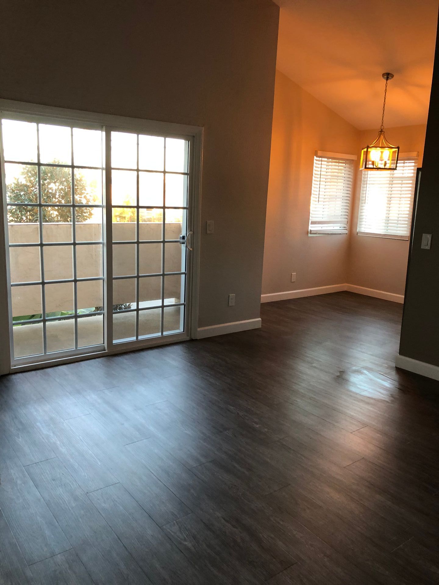 An empty living room with a sliding glass door