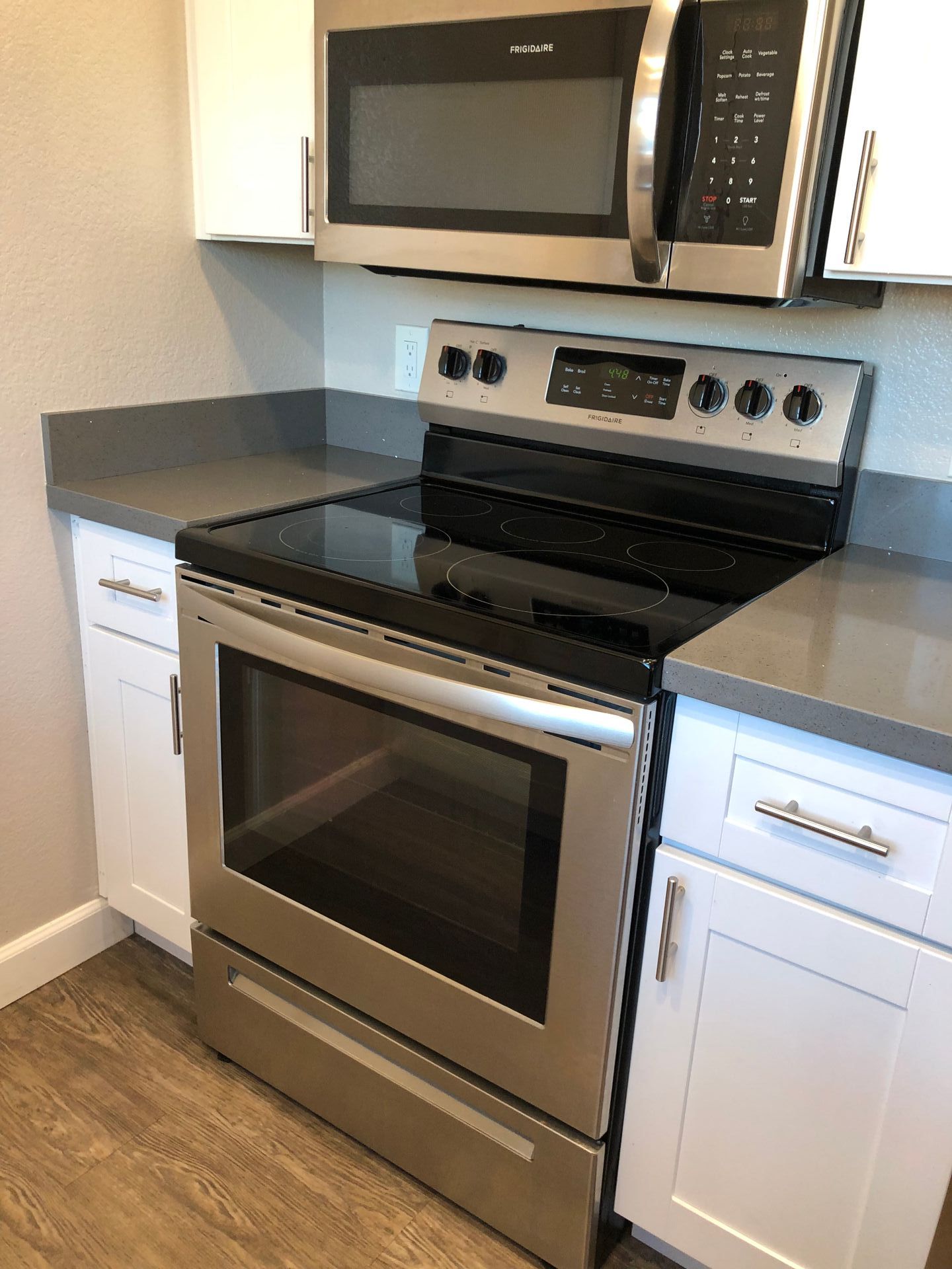 A kitchen with a stove top oven and microwave.