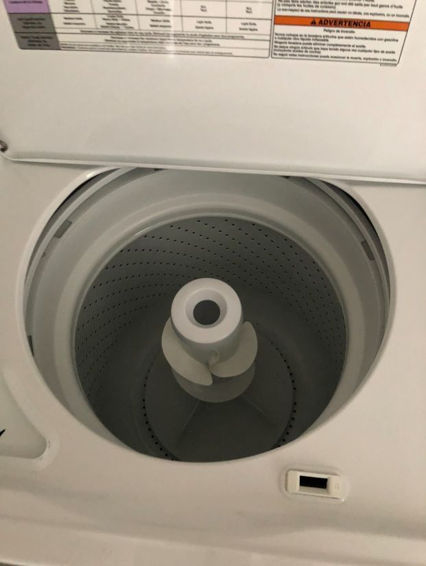 The inside of a washing machine with the lid open