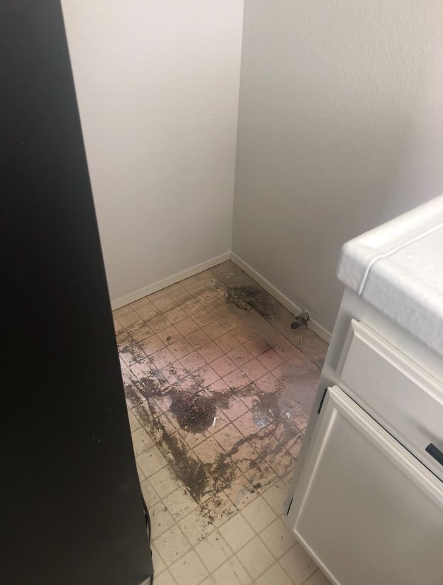 A bathroom with a dirty floor and a sink