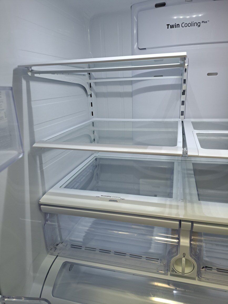 The inside of an empty refrigerator with the door open