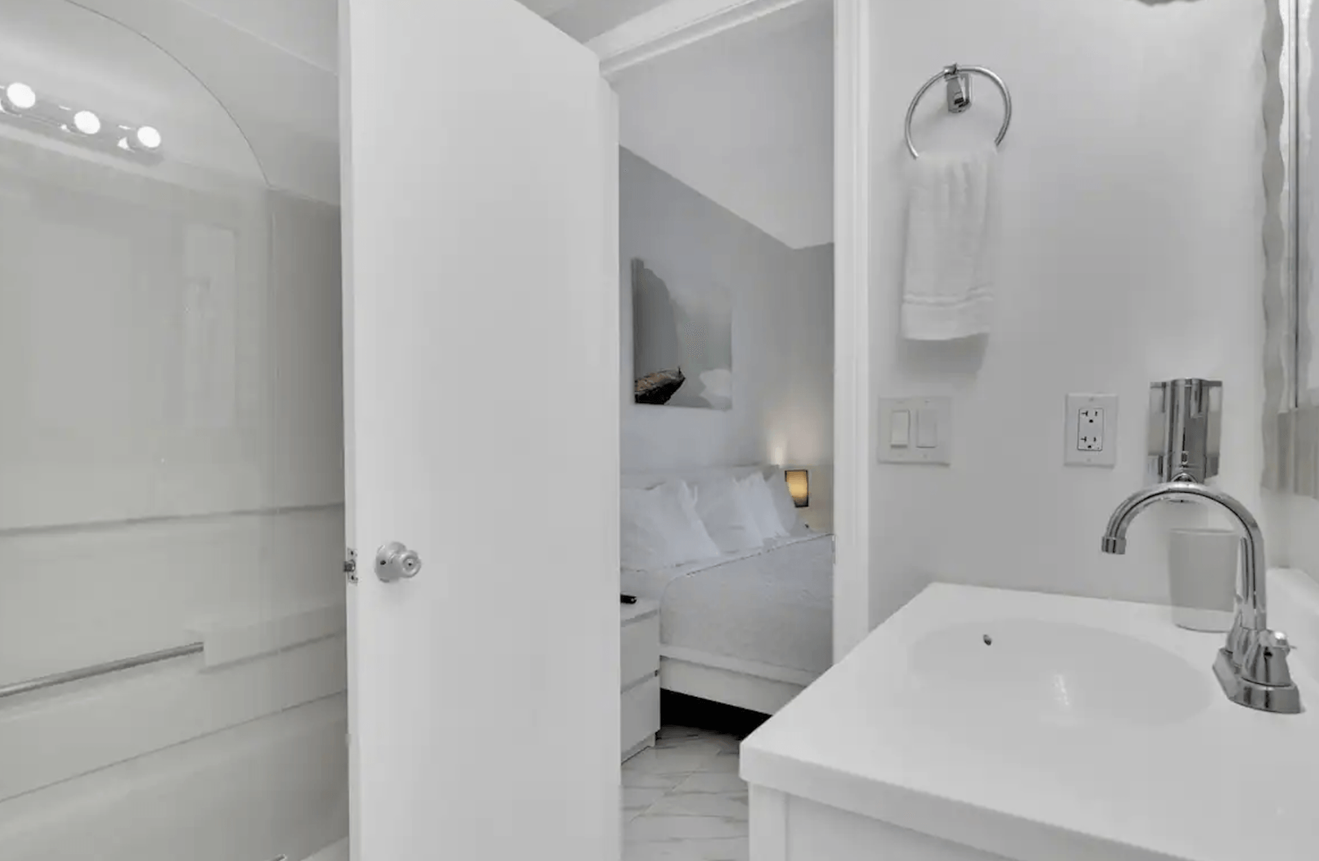 A bathroom with a sink , mirror and shower.
