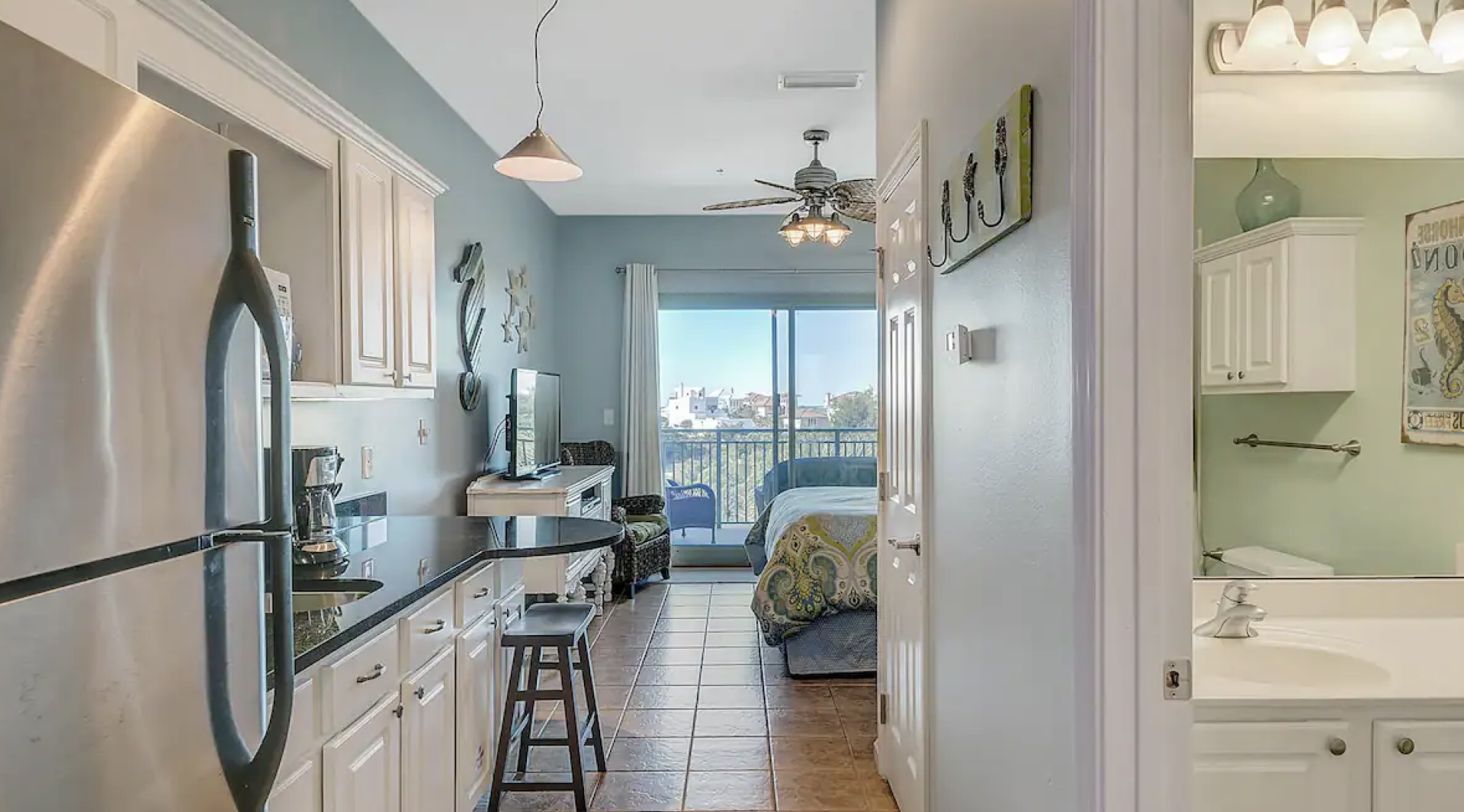 A kitchen with a refrigerator , sink , and stainless steel appliances.
