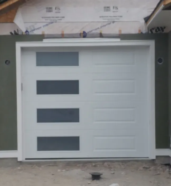 A white garage door with a green wall behind it