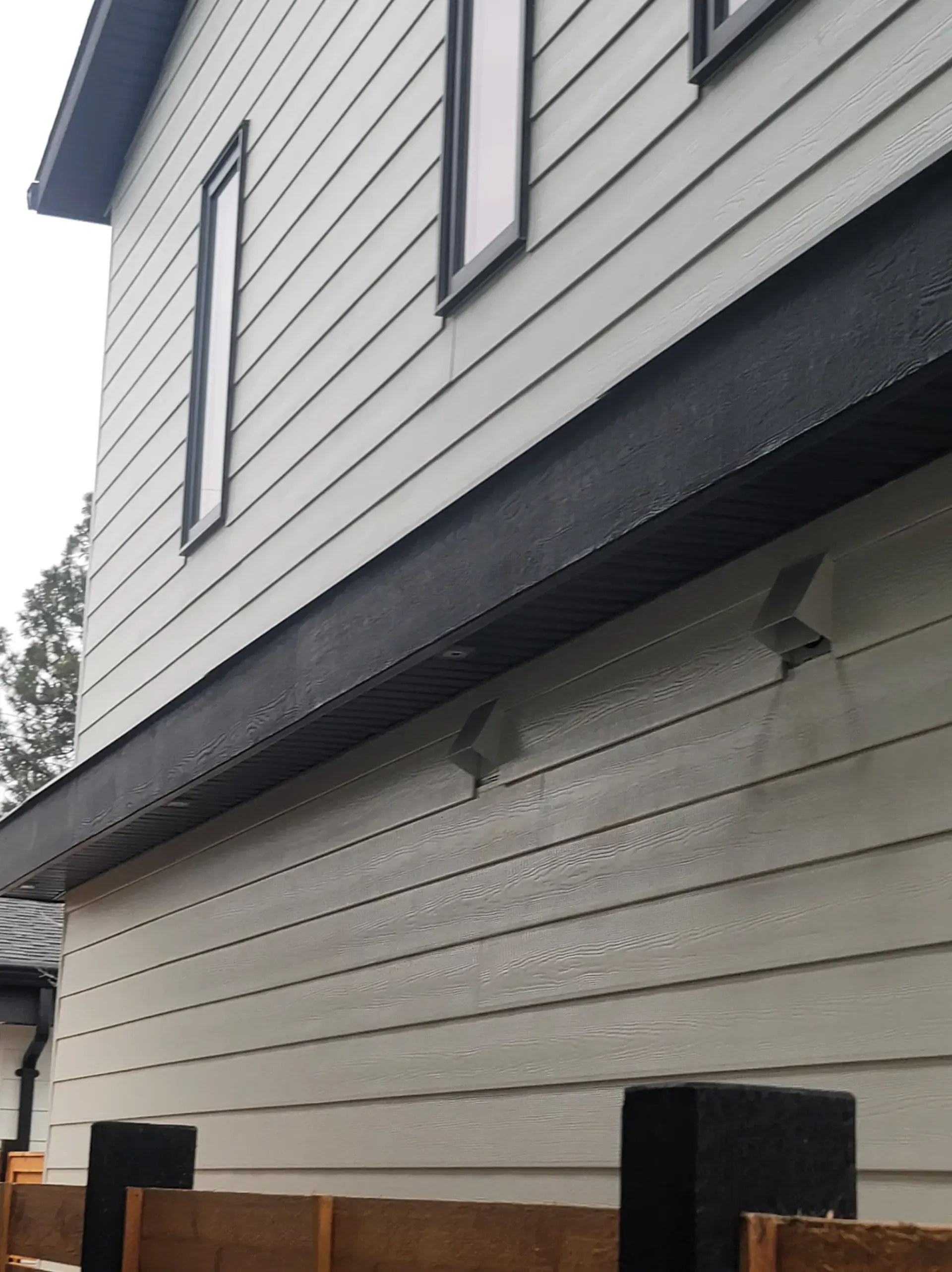 A white house with a wooden fence in front of it