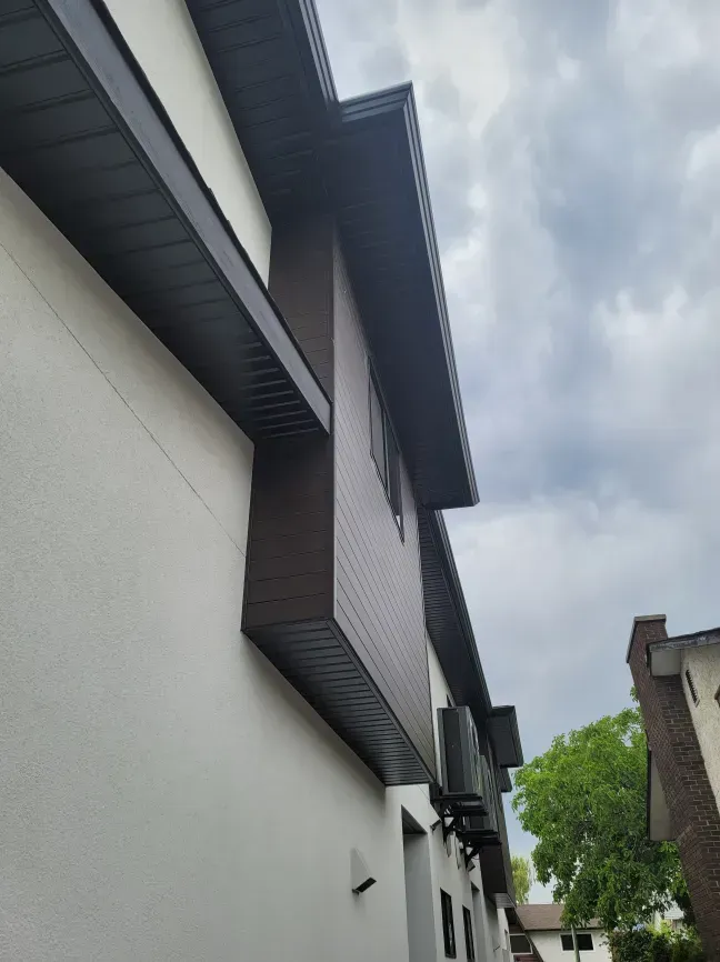 A large white building with a black roof