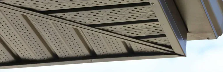 A close up of the roof of a house with a triangle shaped roof.