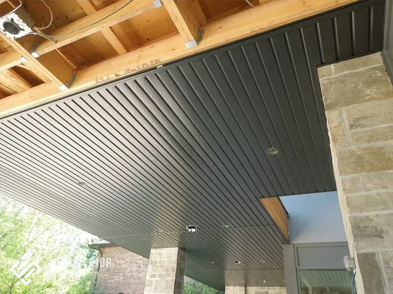 The ceiling of a building with a wooden beam.