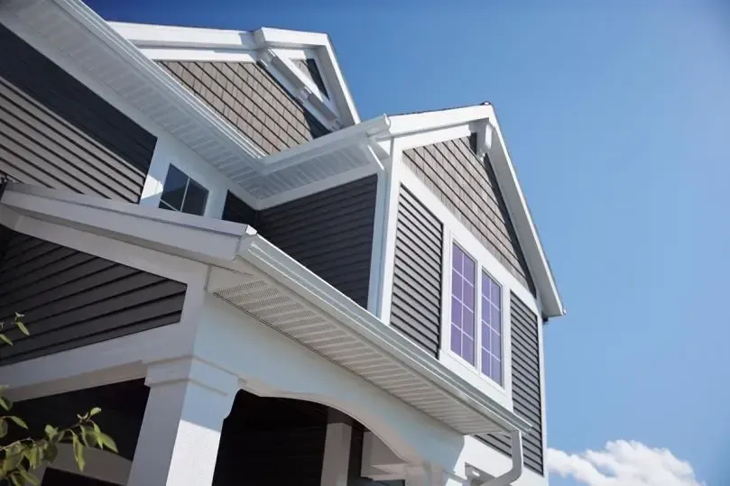The roof of a house with a blue sky in the background