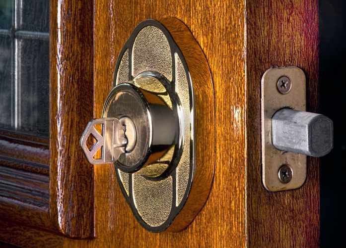 A close up of a door lock with a key in it