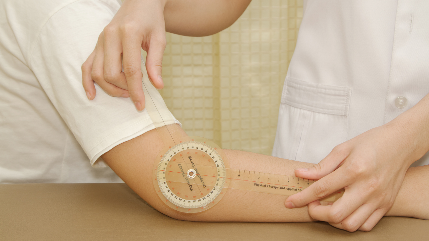 A healthcare professional measuring a patient's elbow flexion using a goniometer.