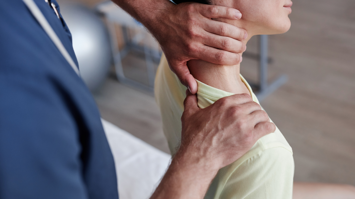 Chiropractor adjusting a woman's neck in a clinic setting.