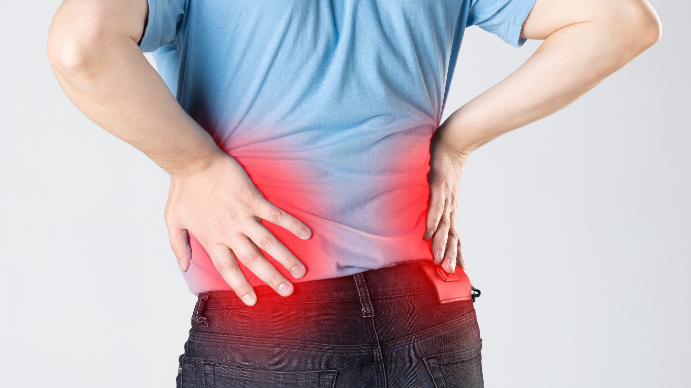 Man with back pain, hands on lower back. Red highlighting indicates pain.