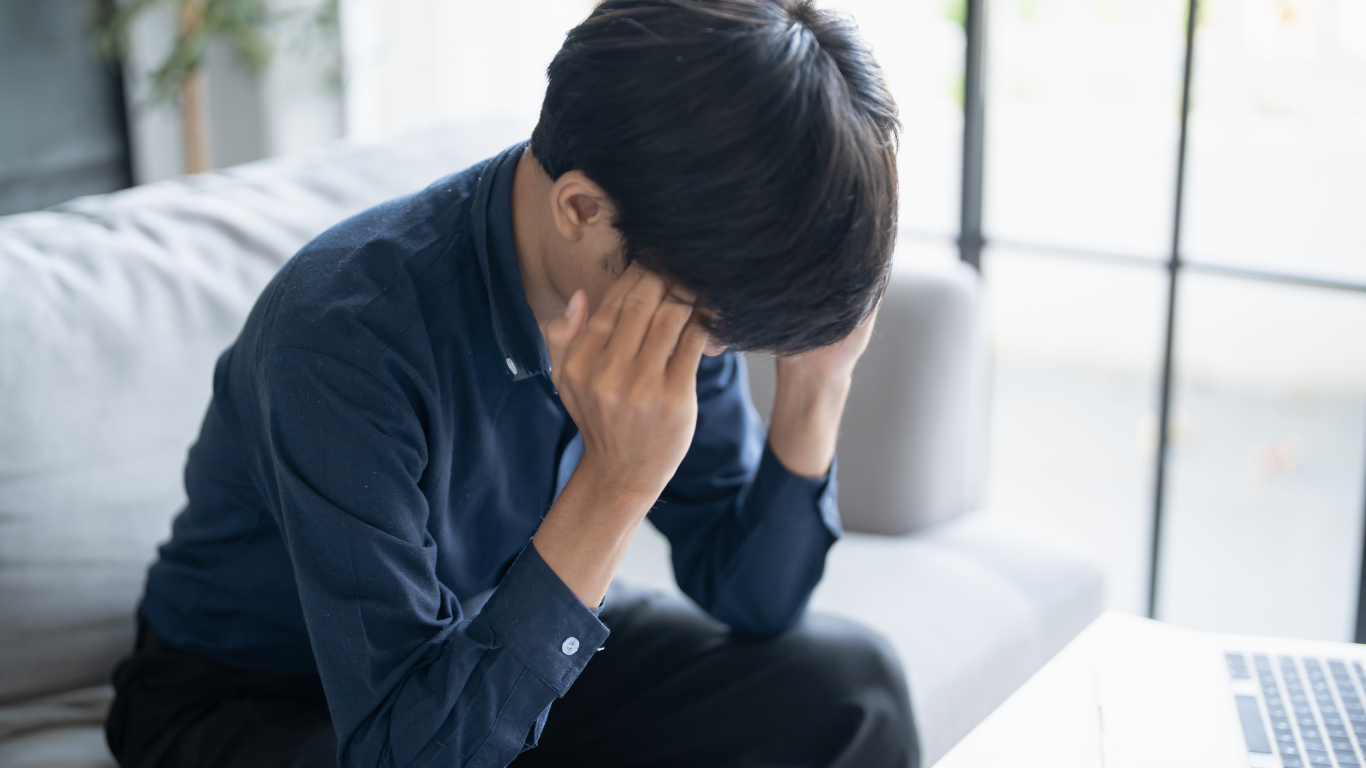 Doctor wrapping a patient's ankle with a bandage, indoor setting.