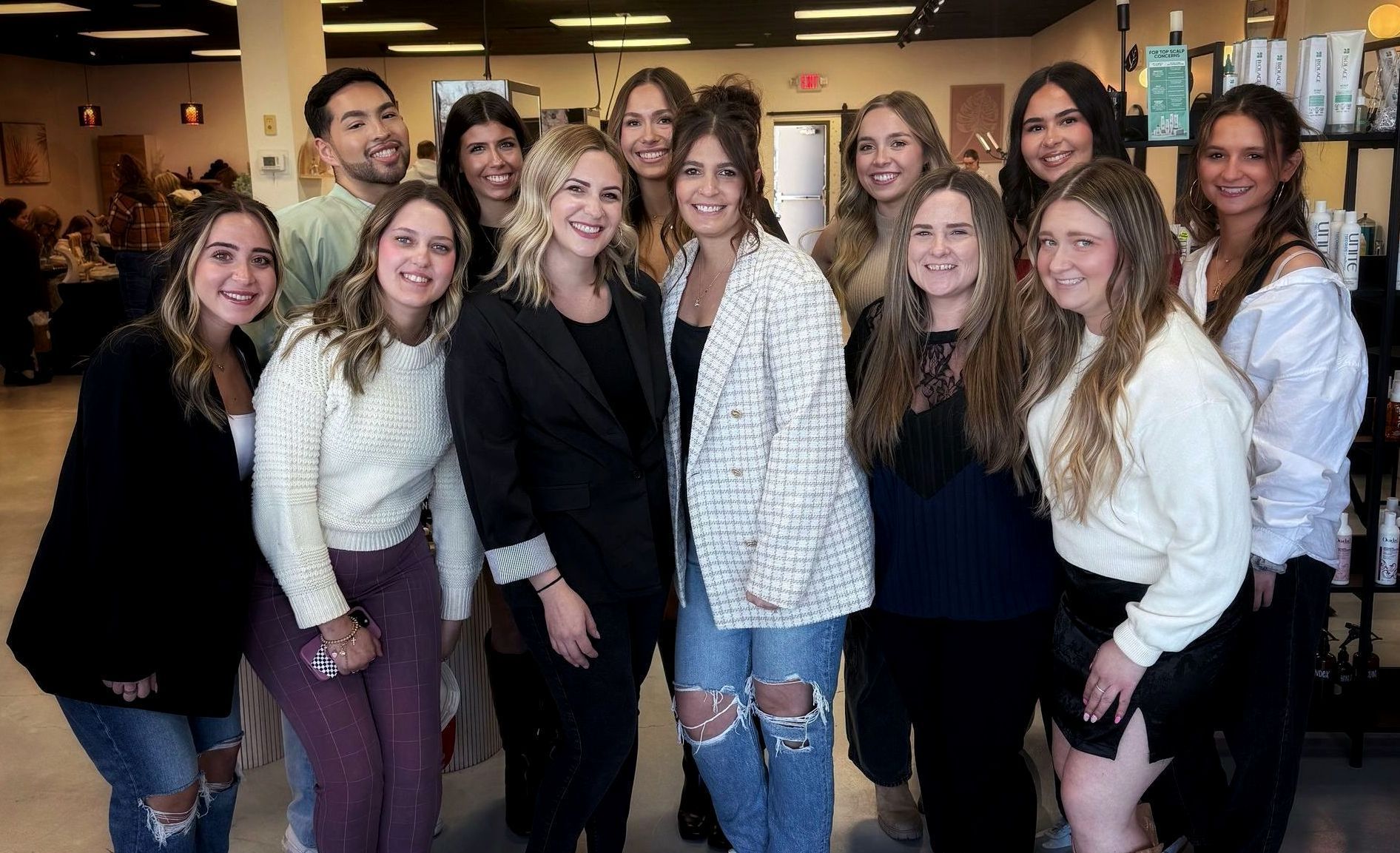 A group of women are posing for a picture together in a room.