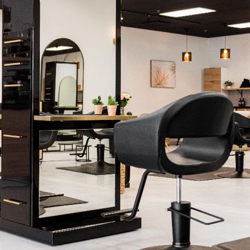 A hair salon with a chair and a mirror