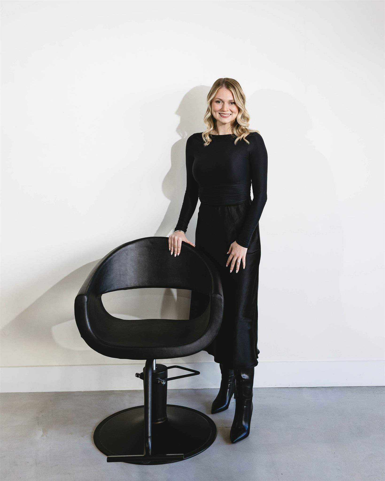 A woman in a black shirt is sitting on a bench