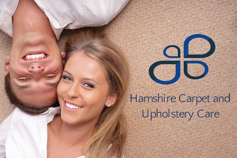 A man and a woman are laying upside down on a carpet.