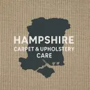 The logo for hampshire carpet and upholstery care is blue and black.