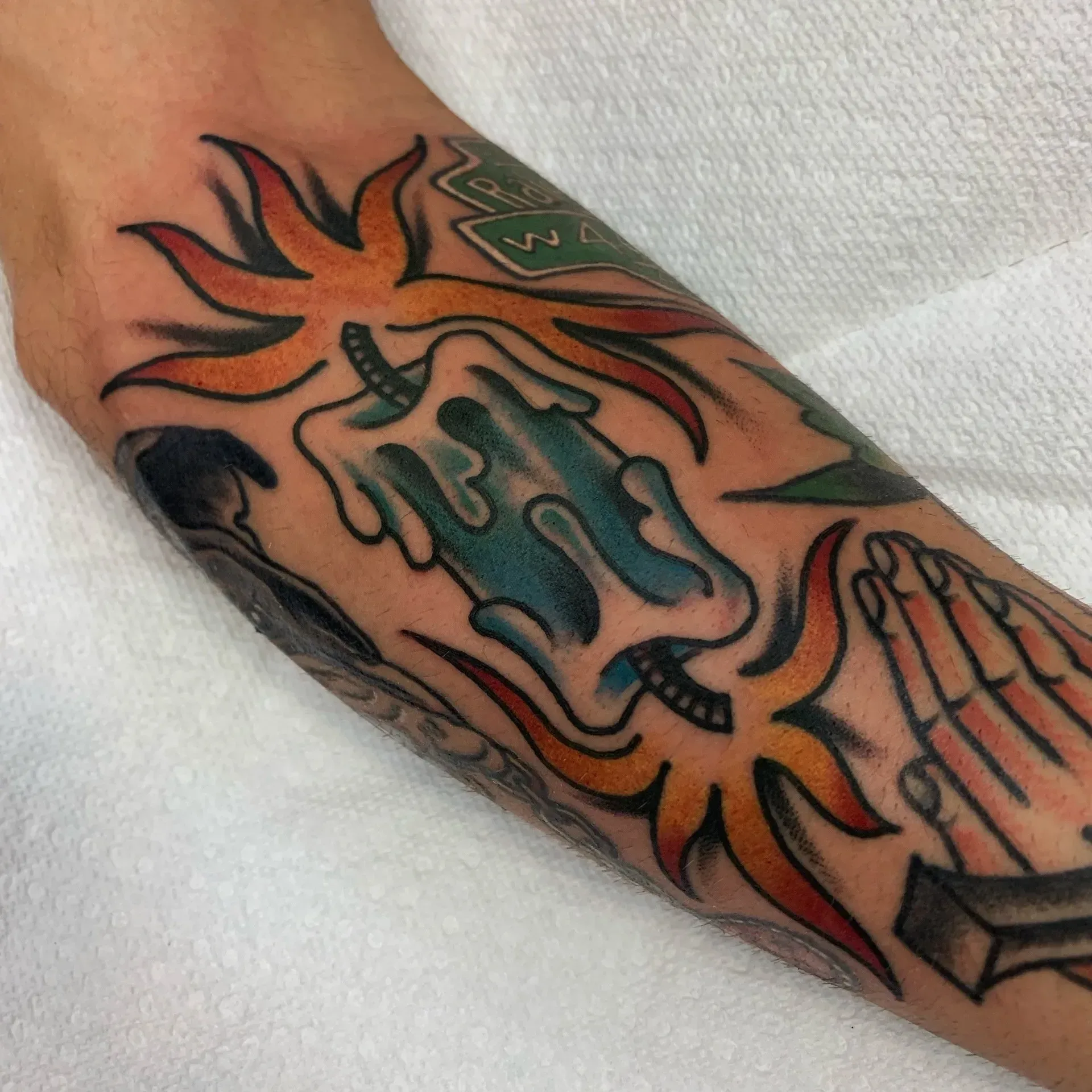 A tattoo on a person 's arm that says ' jesus ' on it