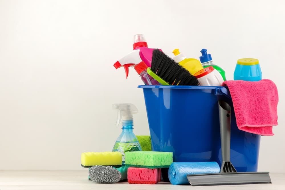 A Blue Bucket Filled with Cleaning Supplies — Complete Clean Home Cleaning in Warrawong, NSW