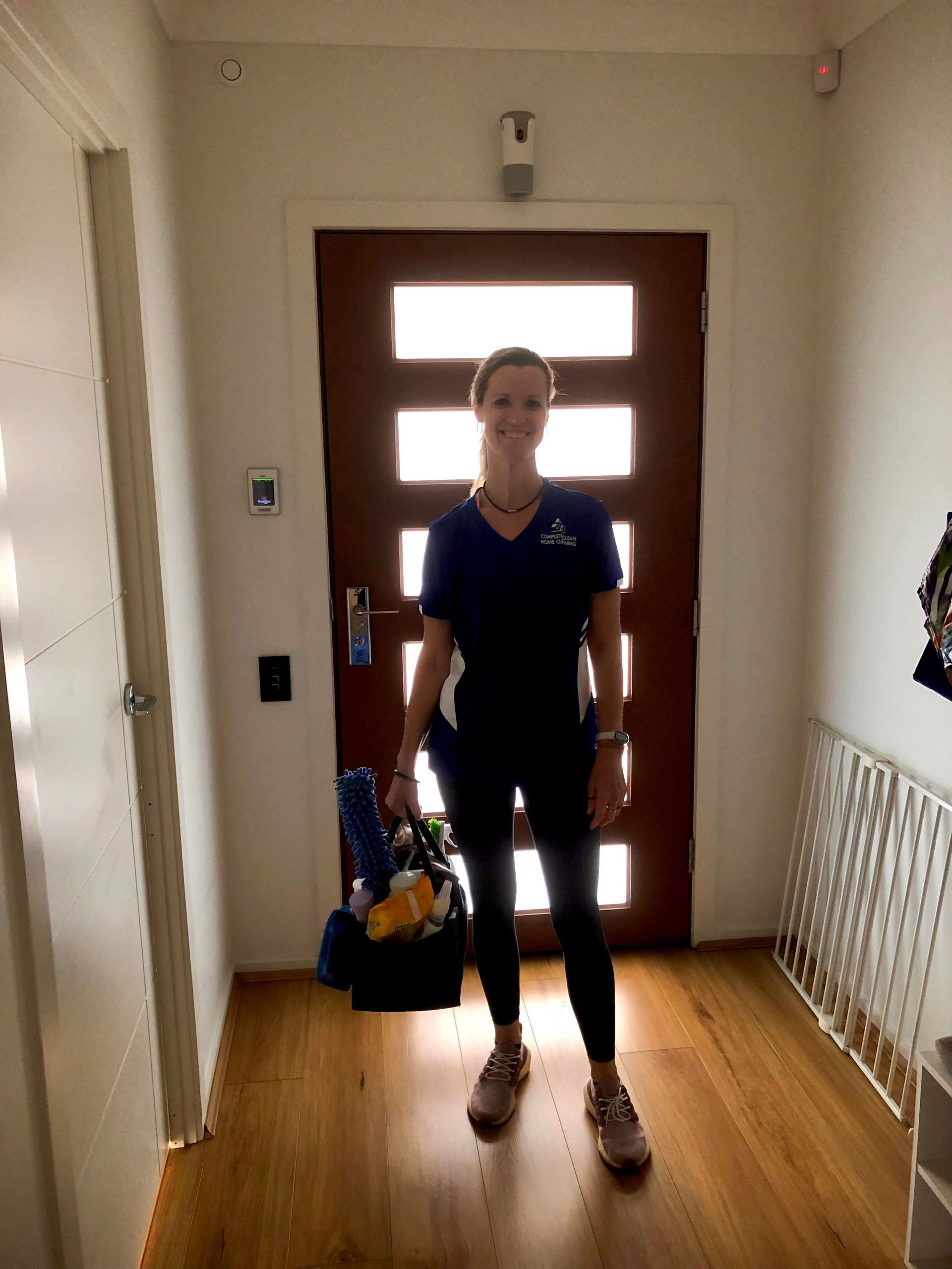 A Person Wearing Yellow Gloves Is Cleaning an Oven — Complete Clean Home Cleaning in Dapto, NSW