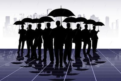 A group of people holding umbrellas in front of a city.