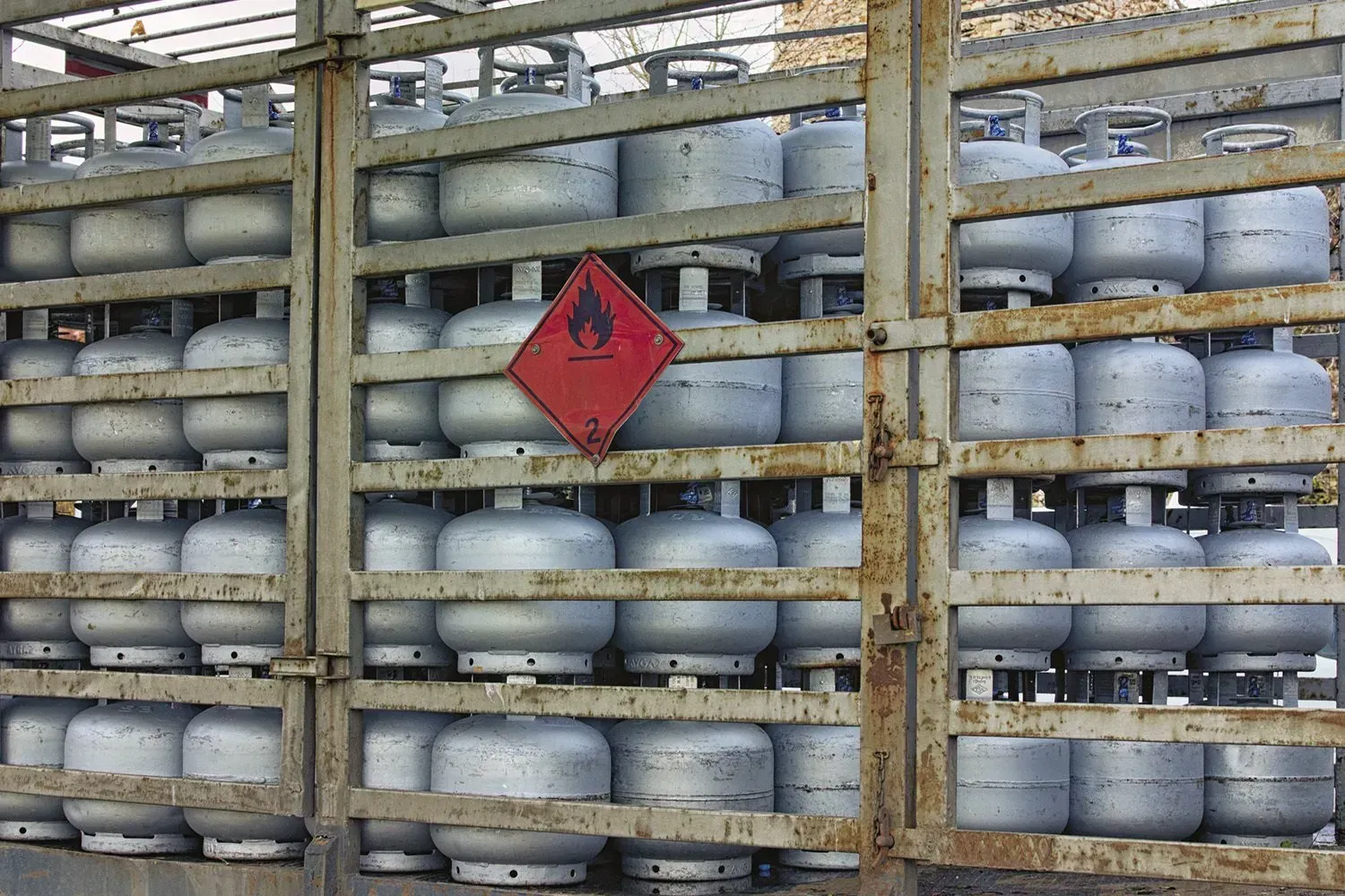 A bunch of gas cylinders are stacked on top of each other