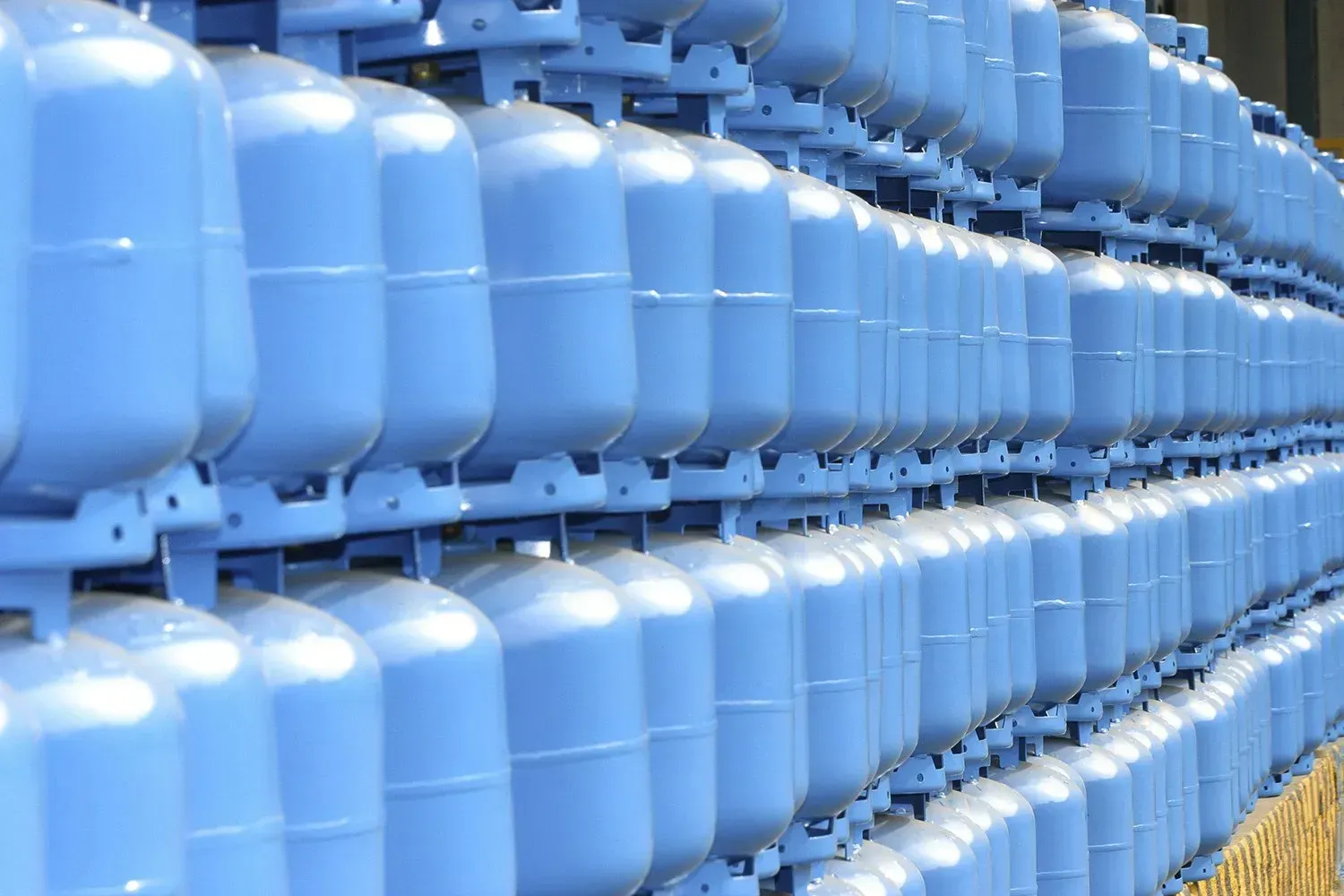 A bunch of blue containers are stacked on top of each other