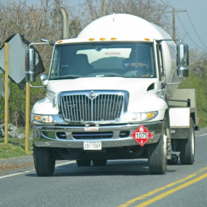 A white truck with a stop sign on the front