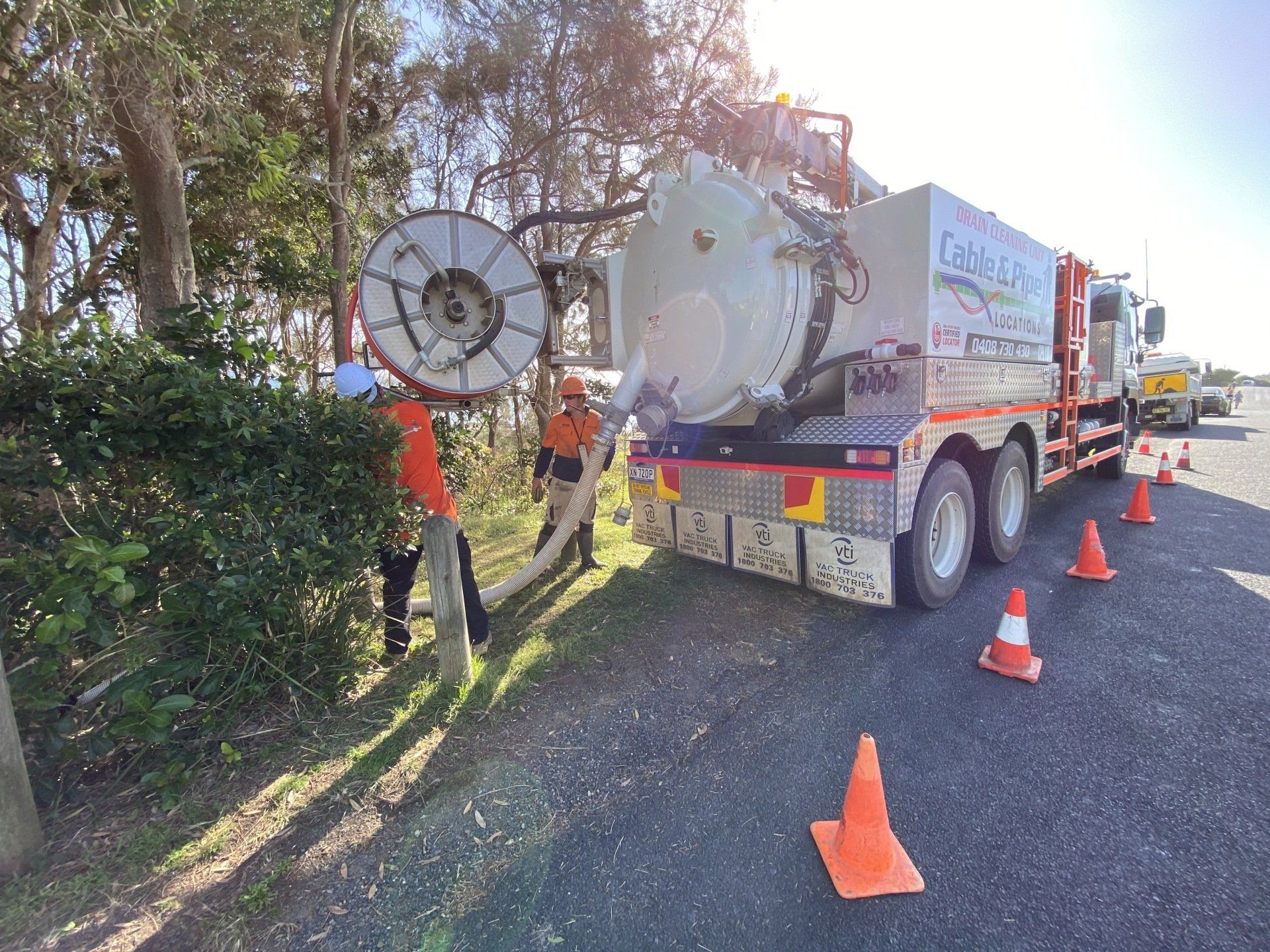 Two Men Working At The Back Of Jetter Truck — Cable & Pipe Locations in Grafton, NSW