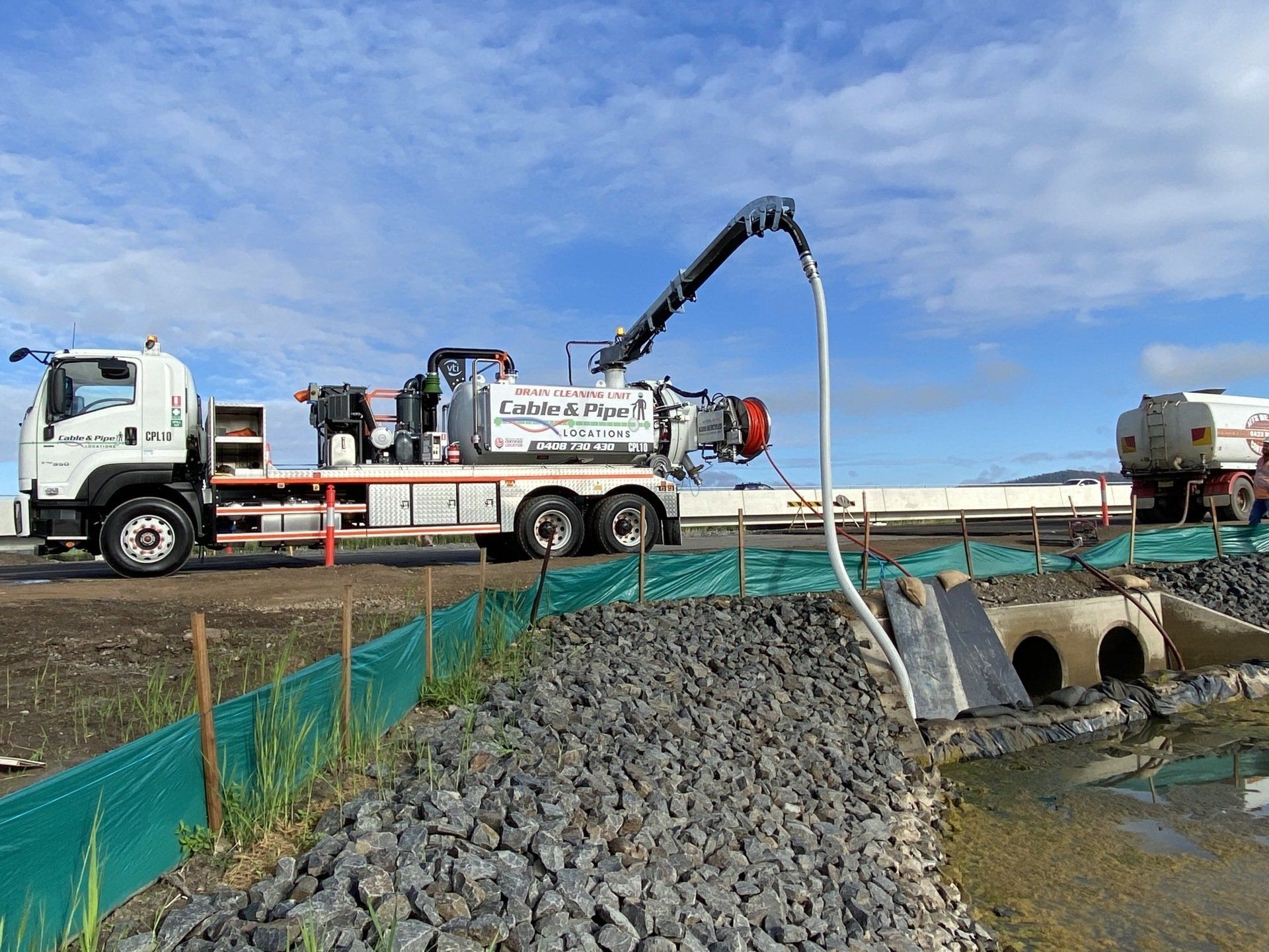A Vacuum Truck Is Pumping Water Into a Pipe — Cable & Pipe Locations in Port Macquarie, NSW